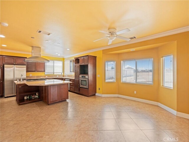 26775 Lakeview, Helendale, CA 92342 - kitchen featuring island range hood, appliances with stainless steel finishes, light countertops, ornamental molding, and plenty of natural light