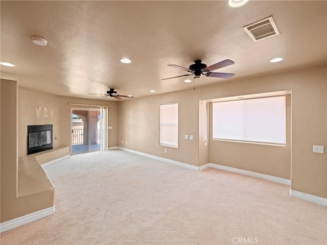 26775 Lakeview, Helendale, CA 92342 - unfurnished living room featuring ceiling fan, a glass covered fireplace, recessed lighting, carpet floors, and baseboards