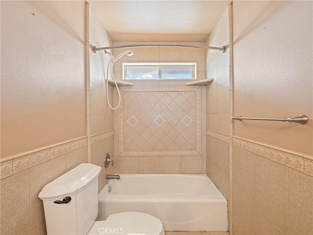 26775 Lakeview, Helendale, CA 92342 - full bathroom with toilet, shower / washtub combination, a wainscoted wall, and tile walls