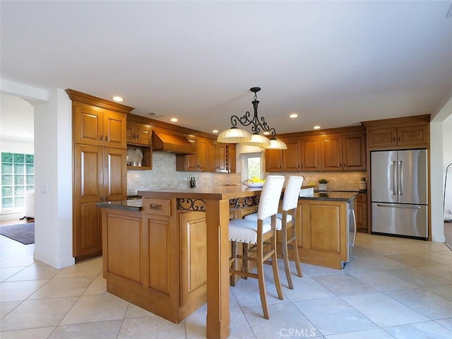3226 Corinna Dr, Rancho Palos Verdes, CA 90275 - kitchen with stainless steel refrigerator, brown cabinets, tasteful backsplash, a kitchen island, and premium range hood