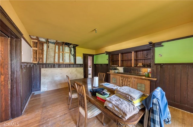 208 Highland Pl, Monrovia, CA 91016 - dining space featuring wooden walls, wainscoting, and wood finished floors