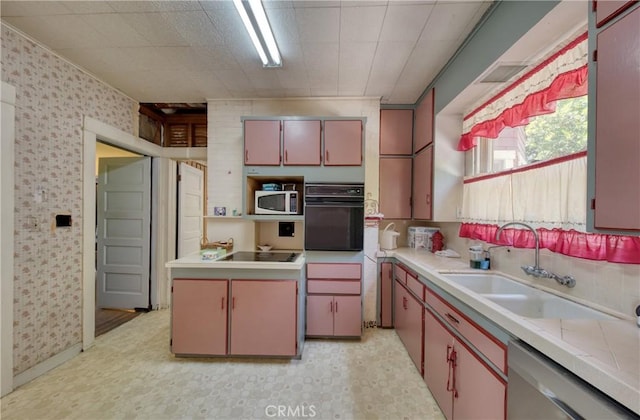 208 Highland Pl, Monrovia, CA 91016 - kitchen with black appliances, light countertops, a sink, wallpapered walls, and light flooring