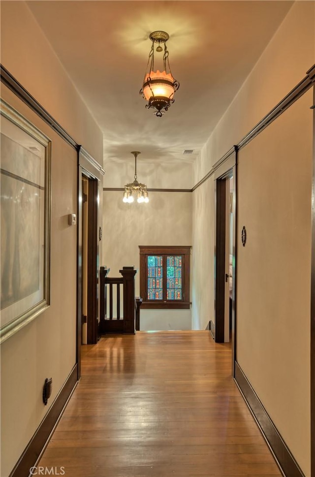 208 Highland Pl, Monrovia, CA 91016 - corridor featuring a chandelier and wood finished floors