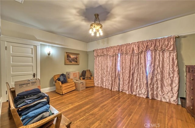 208 Highland Pl, Monrovia, CA 91016 - sitting room featuring wood finished floors, a chandelier, and baseboards