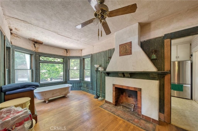208 Highland Pl, Monrovia, CA 91016 - living room featuring a ceiling fan, wood finished floors, a textured ceiling, and a fireplace