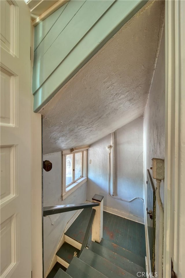 208 Highland Pl, Monrovia, CA 91016 - staircase featuring wood finished floors, baseboards, and a textured ceiling
