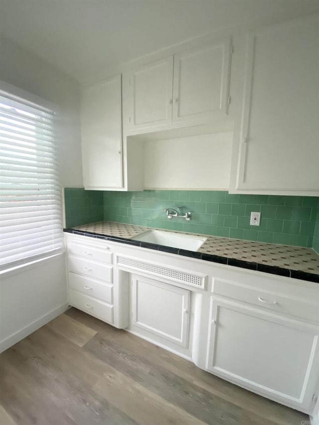 481848321/2 Palm Ave, La Mesa, CA 91942 - kitchen with tile countertops, light wood-type flooring, white cabinets, and a sink
