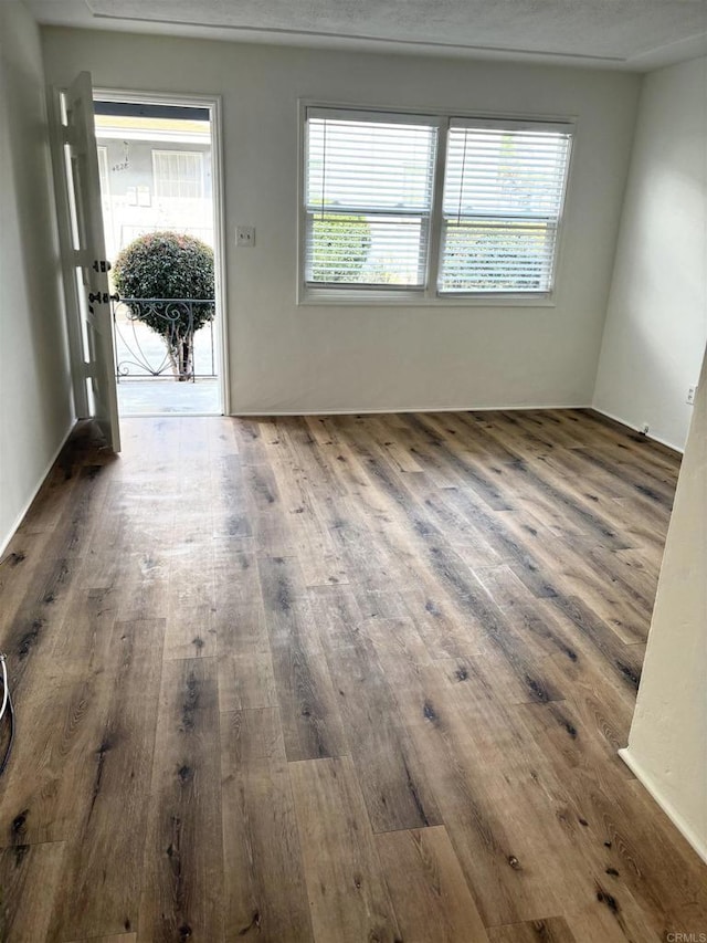 481848321/2 Palm Ave, La Mesa, CA 91942 - empty room with healthy amount of natural light and wood finished floors