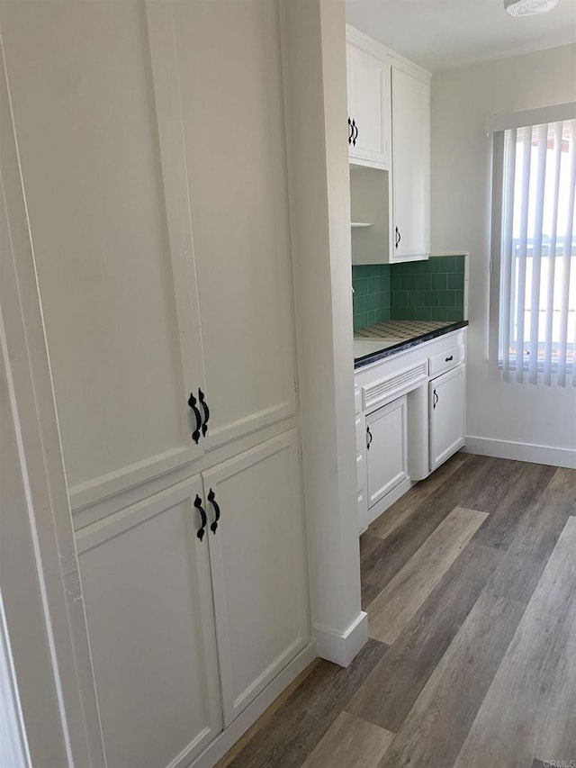 481848321/2 Palm Ave, La Mesa, CA 91942 - kitchen featuring white cabinets, dark wood-style flooring, decorative backsplash, and baseboards