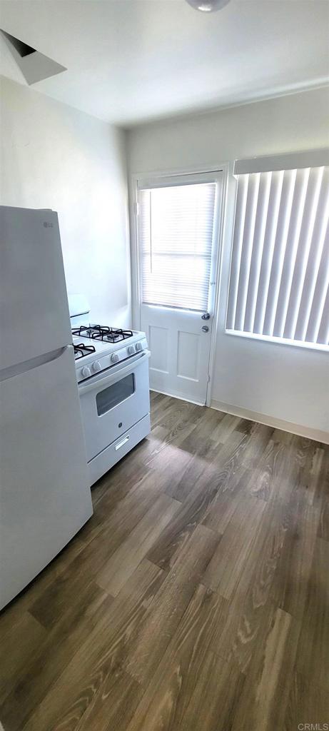 481848321/2 Palm Ave, La Mesa, CA 91942 - kitchen featuring white appliances and dark wood-type flooring