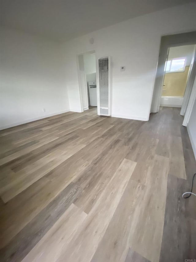 481848321/2 Palm Ave, La Mesa, CA 91942 - empty room with a heating unit, wood finished floors, and baseboards