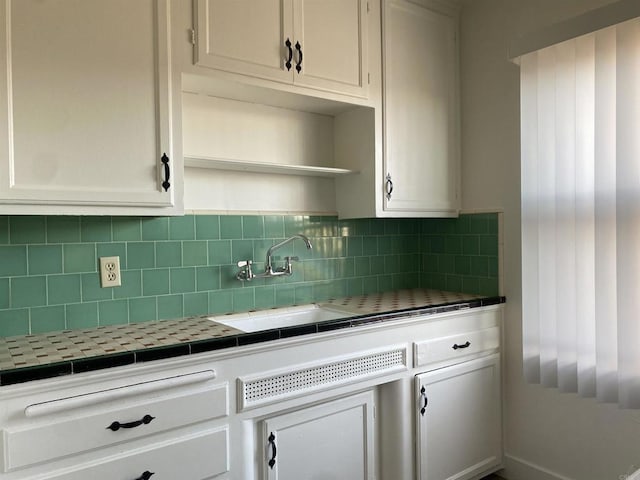 481848321/2 Palm Ave, La Mesa, CA 91942 - kitchen featuring tile countertops, backsplash, white cabinetry, and open shelves
