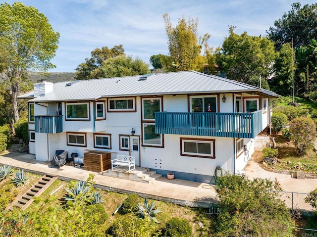1628 Lone Oak Rd, Vista, CA 92084 - rear view of property featuring a balcony, a patio, metal roof, and a chimney