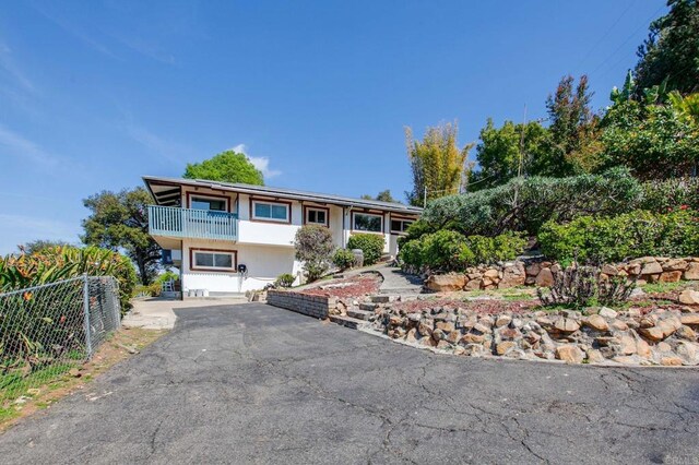 1628 Lone Oak Rd, Vista, CA 92084 - view of front of home with a balcony and asphalt driveway