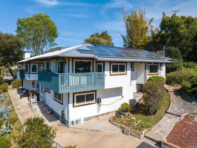1628 Lone Oak Rd, Vista, CA 92084 - view of front facade with a balcony, solar panels, a patio, and stucco siding