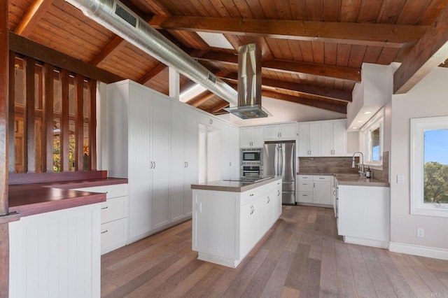 1628 Lone Oak Rd, Vista, CA 92084 - kitchen featuring appliances with stainless steel finishes, a center island, wood-type flooring, white cabinetry, and decorative backsplash