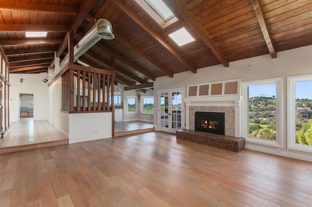 1628 Lone Oak Rd, Vista, CA 92084 - unfurnished living room featuring wood-type flooring, wooden ceiling with exposed beams, a fireplace, a skylight, and high vaulted ceiling