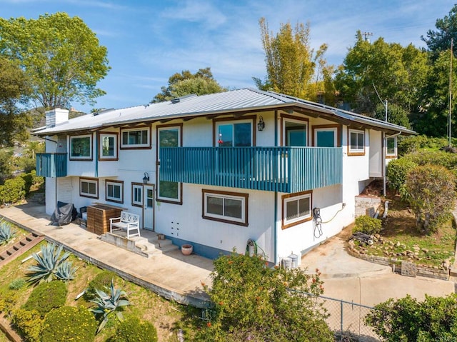 1628 Lone Oak Rd, Vista, CA 92084 - back of property with a balcony, a chimney, a patio area, and metal roof
