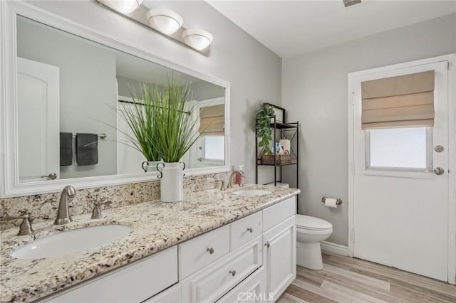 1926 N Vallejo Way, Upland, CA 91784 - full bath featuring double vanity, toilet, wood finished floors, and baseboards