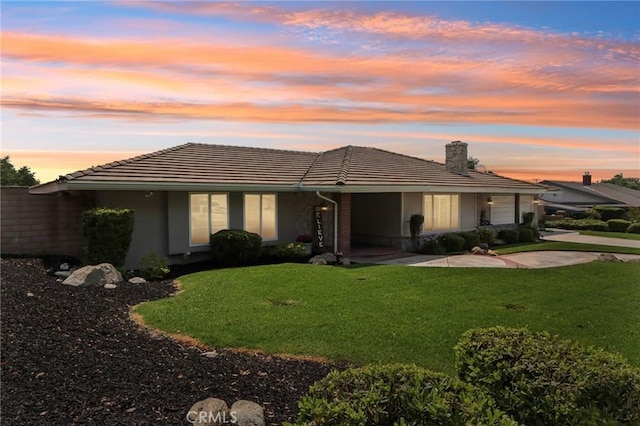 1926 N Vallejo Way, Upland, CA 91784 - rear view of house with a garage, a chimney, driveway, a lawn, and a tiled roof