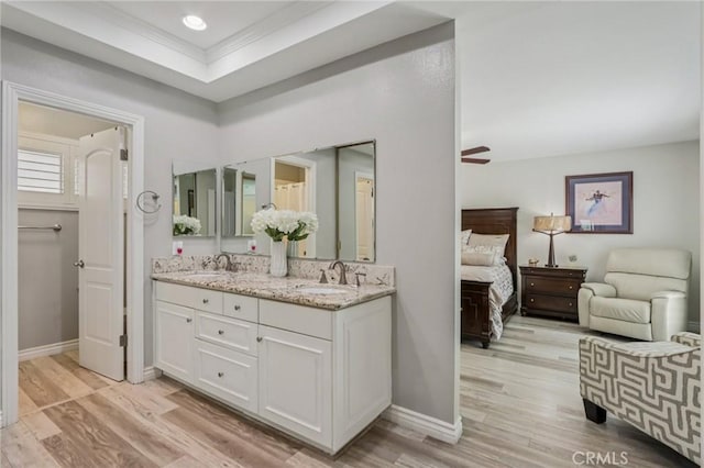 1926 N Vallejo Way, Upland, CA 91784 - ensuite bathroom featuring double vanity, wood finished floors, baseboards, and a ceiling fan
