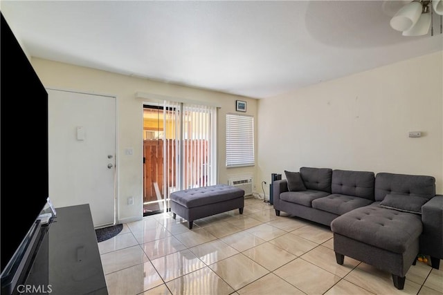 4810 N Vincent Ave, Covina, CA 91722 - living room featuring ceiling fan, baseboards, light tile patterned floors, and a wall unit AC