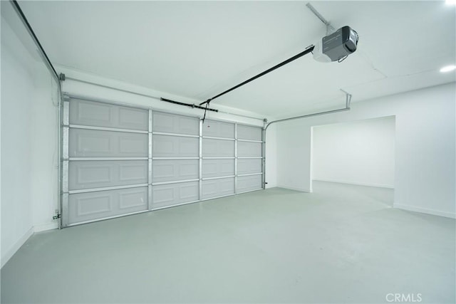 921 W 19th St, Merced, CA 95340 - garage featuring a garage door opener and baseboards