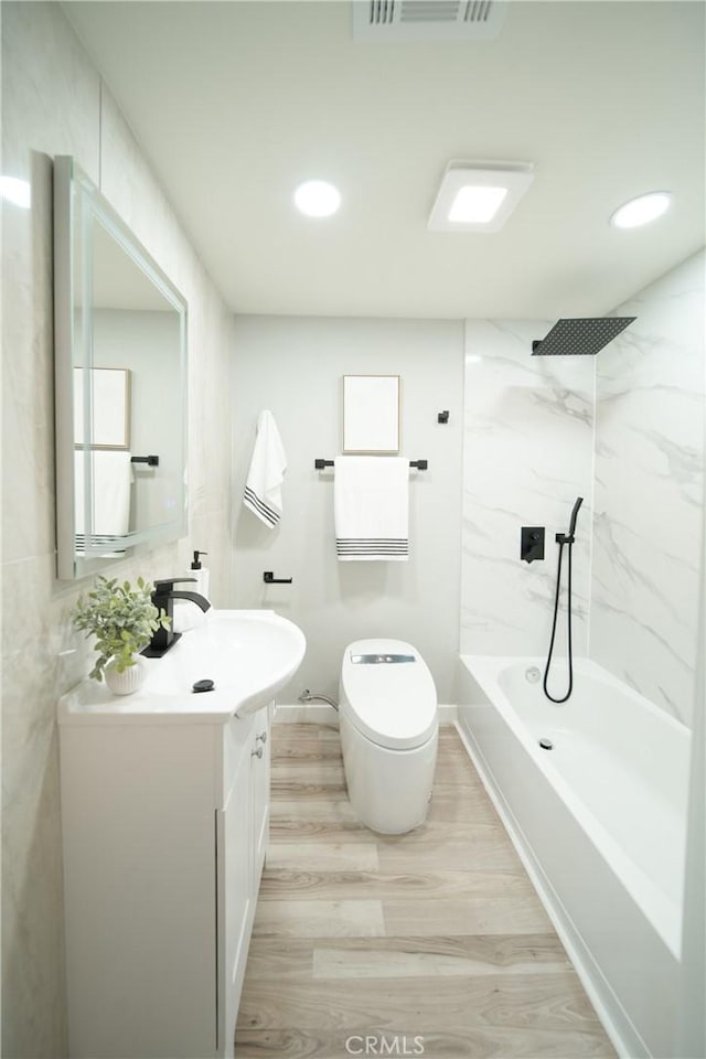 921 W 19th St, Merced, CA 95340 - bathroom with vanity, wood finished floors, washtub / shower combination, and recessed lighting