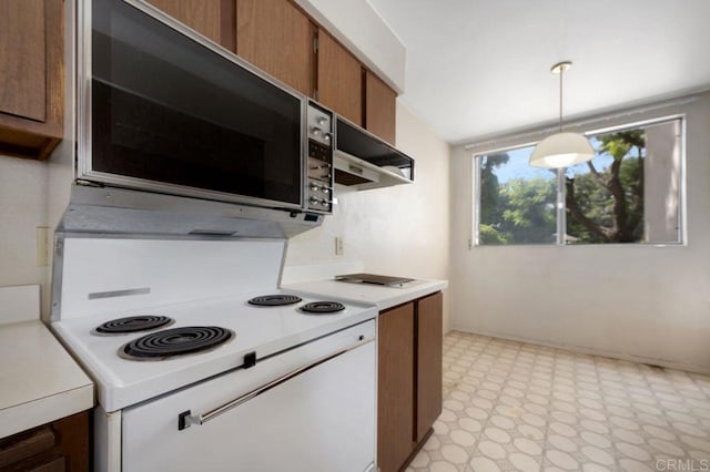 3213 Raintree Cir, Culver City, CA 90230 - kitchen featuring stainless steel microwave, white electric range, light countertops, and brown cabinets