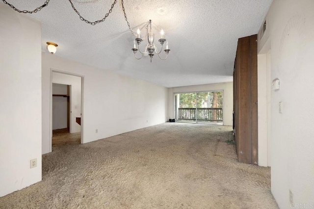 3213 Raintree Cir, Culver City, CA 90230 - empty room with carpet flooring, a chandelier, and a textured ceiling