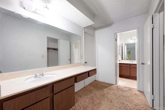 3213 Raintree Cir, Culver City, CA 90230 - full bathroom with vanity, a textured ceiling, and a closet