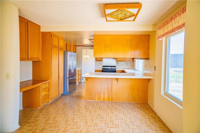 2868 Corte Caballos, Camarillo, CA 93010 - kitchen featuring freestanding refrigerator, range, a peninsula, and light countertops