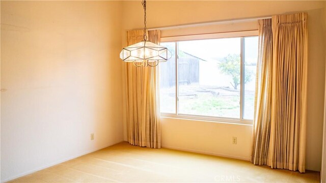 2868 Corte Caballos, Camarillo, CA 93010 - empty room featuring a chandelier, healthy amount of natural light, and light colored carpet
