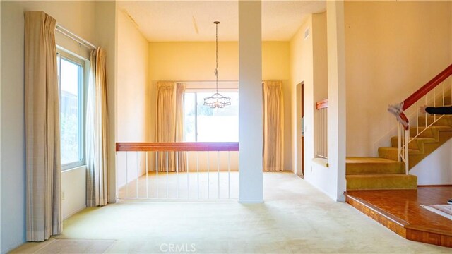 2868 Corte Caballos, Camarillo, CA 93010 - hall with carpet flooring, a chandelier, and stairway