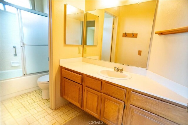 2868 Corte Caballos, Camarillo, CA 93010 - bathroom with toilet, vanity, enclosed tub / shower combo, and brick patterned floors