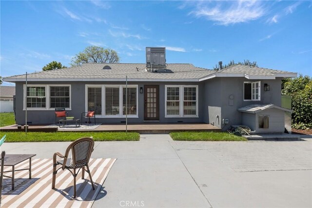11012 Montgomery Ave, Granada Hills, CA 91344 - rear view of property featuring a patio area, stucco siding, cooling unit, and roof with shingles