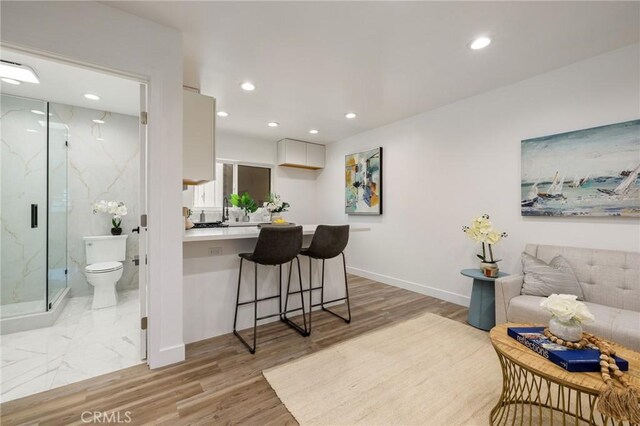11012 Montgomery Ave, Granada Hills, CA 91344 - living room featuring light wood finished floors, recessed lighting, and baseboards