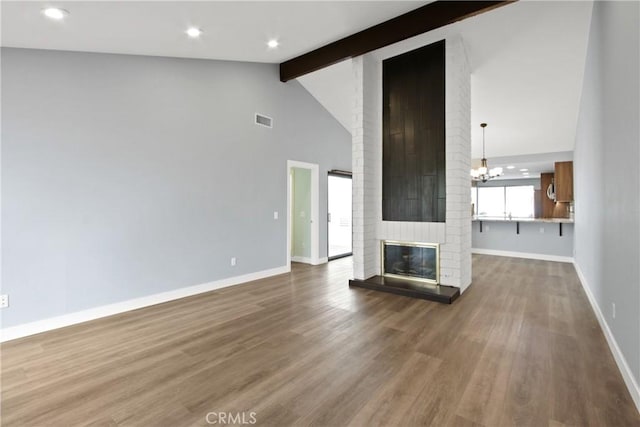 3520 Paseo Flamenco, San Clemente, CA 92672 - unfurnished living room featuring baseboards, wood finished floors, a chandelier, a brick fireplace, and recessed lighting