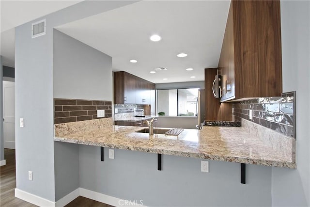 3520 Paseo Flamenco, San Clemente, CA 92672 - kitchen featuring a sink, tasteful backsplash, a breakfast bar area, baseboards, and recessed lighting