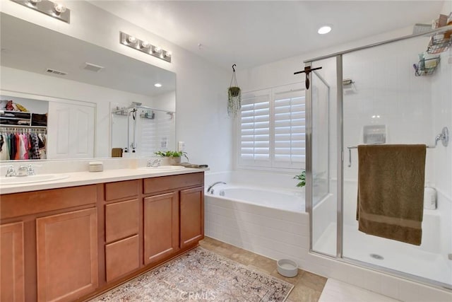 18026 Crabapple Ct, San Bernardino, CA 92407 - full bathroom with a stall shower, a garden tub, double vanity, tile patterned flooring, and a walk in closet