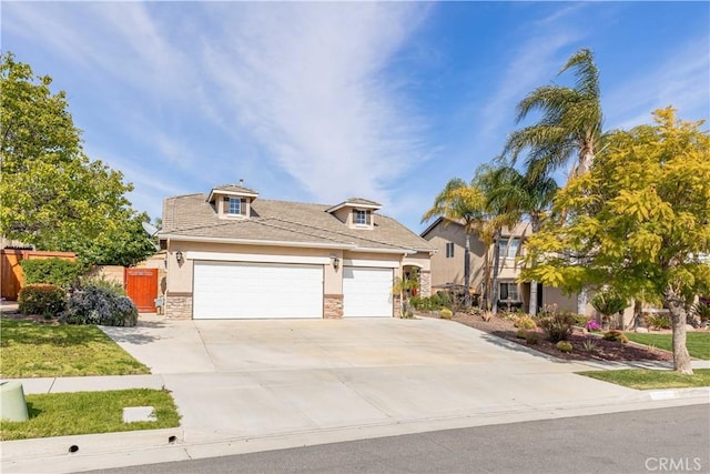 38260 Willow Ct, Murrieta, CA 92562 - view of front facade featuring stucco siding, driveway, stone siding, and a garage