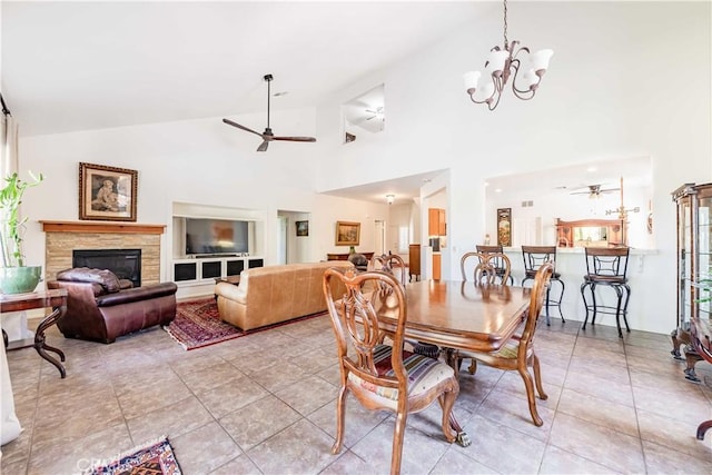 38260 Willow Ct, Murrieta, CA 92562 - dining space featuring ceiling fan, a glass covered fireplace, a chandelier, light tile patterned floors, and high vaulted ceiling