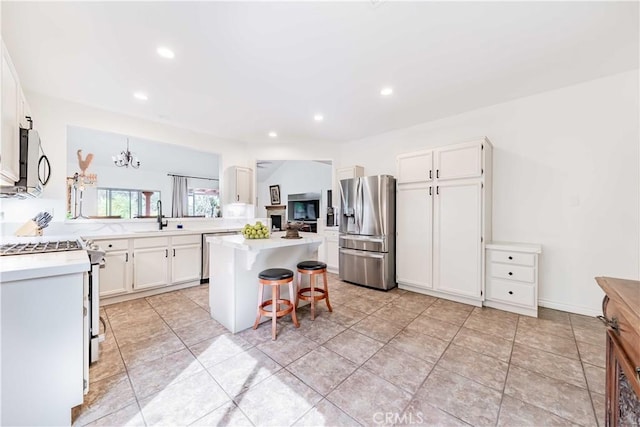 38260 Willow Ct, Murrieta, CA 92562 - kitchen featuring stainless steel appliances, a sink, a breakfast bar, light countertops, and recessed lighting