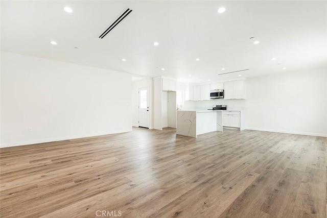 13934 Filmore St, Pacoima, CA 91331 - unfurnished living room with recessed lighting, light wood finished floors, and baseboards