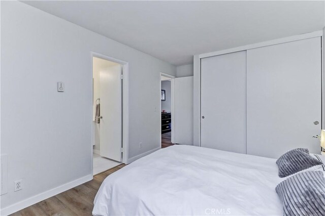 2032 E Bermuda St Unit 103, Long Beach, CA 90814 - bedroom with wood finished floors, a closet, and baseboards