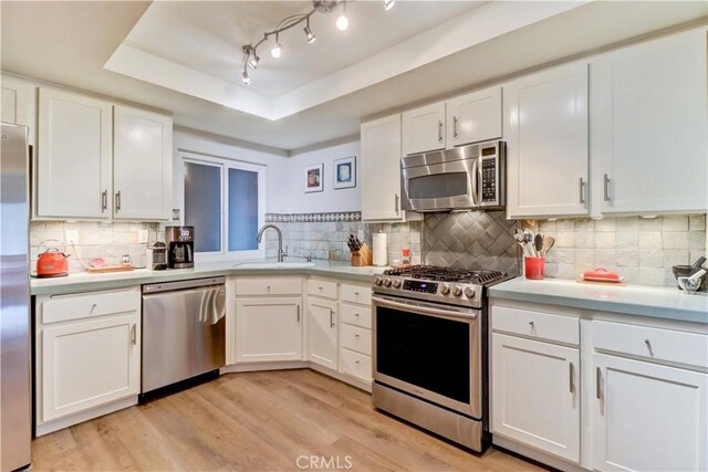 2032 E Bermuda St Unit 103, Long Beach, CA 90814 - kitchen with appliances with stainless steel finishes, a sink, white cabinetry, and light countertops