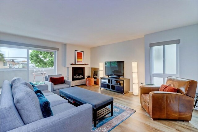 2032 E Bermuda St Unit 103, Long Beach, CA 90814 - living area with light wood-style flooring and a fireplace