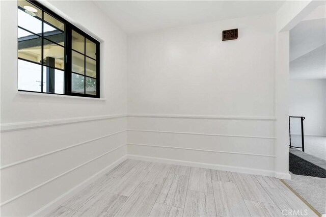 1315 E Wingate St, Covina, CA 91724 - unfurnished room featuring plenty of natural light, wood finished floors, and baseboards