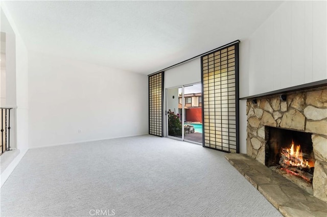 1315 E Wingate St, Covina, CA 91724 - unfurnished living room featuring a stone fireplace and carpet floors