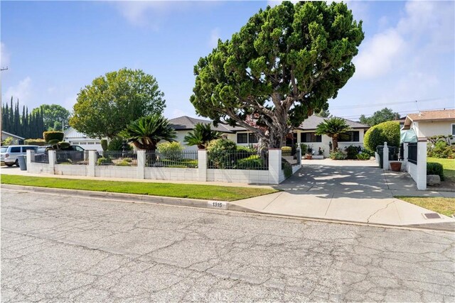 1315 E Wingate St, Covina, CA 91724 - view of property hidden behind natural elements with a fenced front yard and a residential view